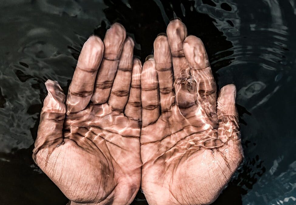 crop man with hands under transparent water